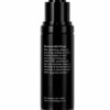 This image shows a sleek black skincare product bottle with a pump dispenser, including instructions for usage against a white background.