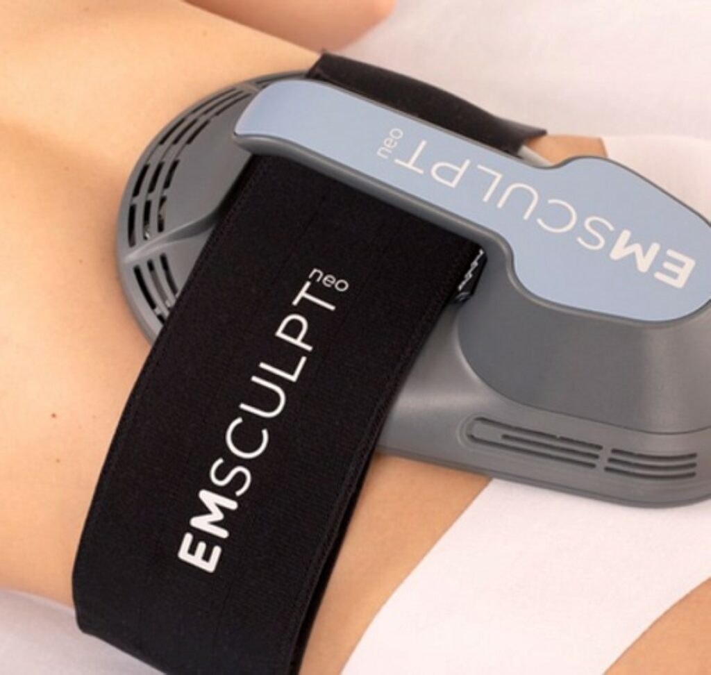 The image shows an EMSculpt device attached to a person's arm, with the logo visible, implying its use for muscle stimulation or toning.