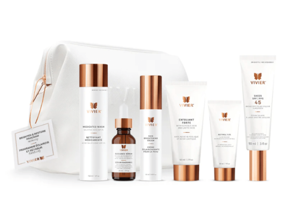 This is an image of a skincare product set by Vivier, featuring various bottles and tubes arranged neatly beside a white cosmetic bag with a tag.