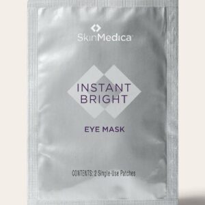 This is a silver-colored packet labeled "SkinMedica Instant Bright Eye Mask," containing two single-use patches, with a minimalistic and clean design.