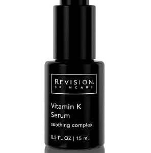 The image features a sleek, black bottle of Revision Skincare Vitamin K Serum with a pump dispenser, labeled with white text, on a reflective surface.