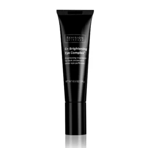 The image shows a black tube of Revision Skincare C+ Brightening Eye Complex, a treatment for dark circles and under-eye puffiness.