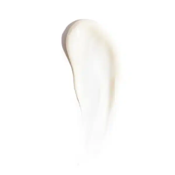 This image shows a dollop of creamy white substance, possibly lotion or cosmetic cream, smeared against a bright white background with a soft texture.