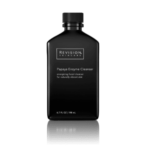 A sleek, black bottle with white text labeled "REVISION SKINCARE Papaya Enzyme Cleanser" against a white background, indicating a facial cleanser product.