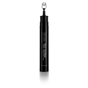 The image displays a skincare product, specifically a Revox™ Line Relaxer, presented in a sleek black tube with a metallic applicator tip.