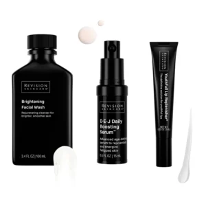 Three Revision Skincare products: Brightening Facial Wash, DEJ Daily Boosting Serum, YouthFull Lip Replenisher. Dark packaging, visible product textures included.